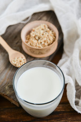 sesame milk sesame seed in a glass on wooden background, concept of healthy eating, organic food, gluten-free and aslacton vegetable milk.