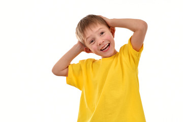 Cheerful child on a white background. Yellow T-shirt. Good mood.