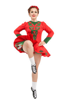 Beautiful woman in red dress for Irish dance jumping isolated