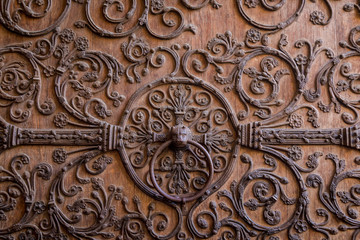 Old wooden door with a metallic pattern close-up. The cathedral Notre-Dame de Paris