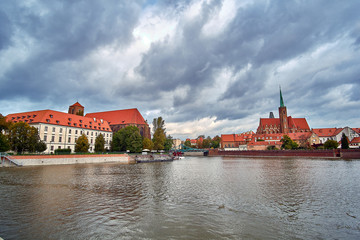 Obraz premium Wroclaw Old Town. Cathedral Island (Ostrow Tumski) is the oldest part of the city at the sunset. Cathedral of St. John and Blessed Virgin Mary Church on Island Piasek and Odra (Oder) river 