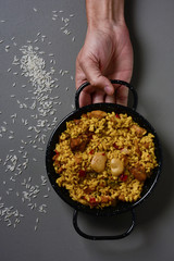 man with a typical spanish paella valenciana