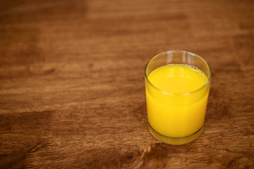 orange juice on a wooden background