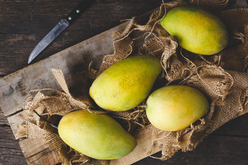 Ripe mangoes on the old wood