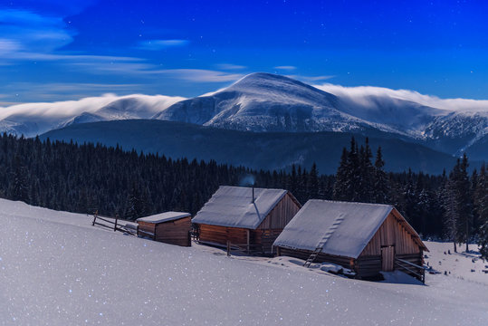 cabins under moonlight in winter