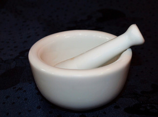 White Isolated Porcelain Mortar and Pestle on Dark Background