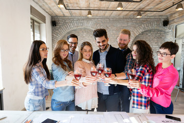 Office colleagues celebrating achievement of company goals