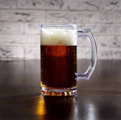 Mug with beer on the table.