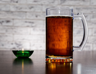 Mug with beer on the table.