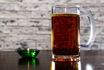 Mug with beer on the table.