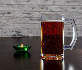 Mug with beer on the table.