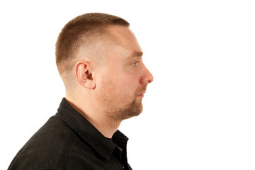 Portrait of the young unshaven man in profile