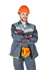 Smiling young builder, looking at camera. Repair and construction. Isolated over white background.