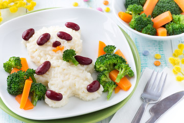 Fun food for kids - cute panda bear made of rice and red beans served with carrots and broccoli. Overhead view