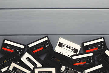 Obraz premium Vintage audio cassettes border on gray planks background