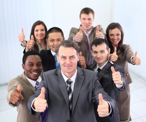 happy business team holding thumbs up