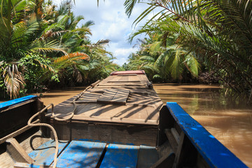 Boating on a dirty river Mekong Delta, Vietnam