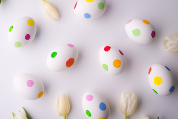 Fototapeta na wymiar Flowers and dotty eggs on a white background.