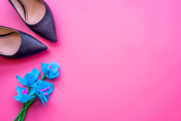black lady shoes with flowers on pink background