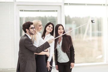 successful business team is doing a selfie in the lobby of the modern office