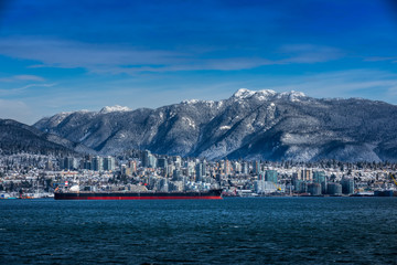 Tanker and Rocky Mountains, North Vancouver, British Colombia, Canada.