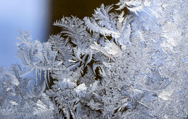 Beautiful  ice pattern on window in winter. Frosty winter pattern at  glass.