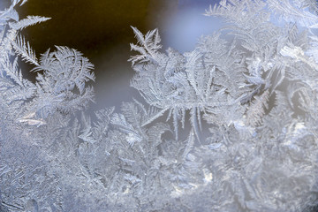 Beautiful  ice pattern on window in winter. Frosty winter pattern at  glass.