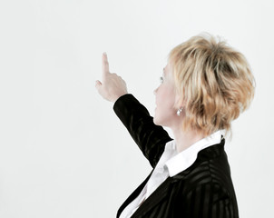 rear view.successful business woman showing at blank screen