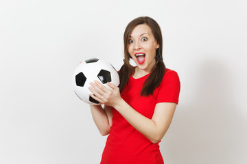 Smiling European young woman, two fun pony tails, football fan or player in red uniform holding classic soccer ball isolated on white background. Sport play football health, healthy lifestyle concept.