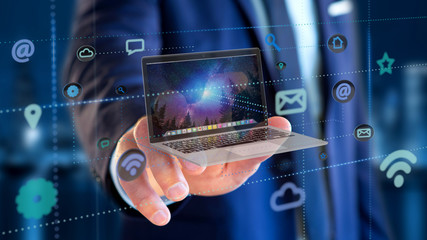 Businessman holding a Computer surrounding by app and social icon - 3d render