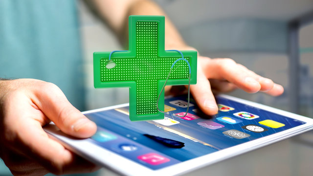 Businessman using a smartphone with a Lighting pharmacy cross and a stethoscope - 3d render