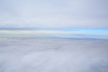 Fototapeta na wymiar peak view: half foggy ground and half cloudy sky