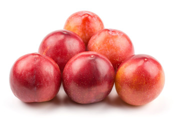 Fototapeta na wymiar Six plums red orange isolated on white background like billiard balls triangle.