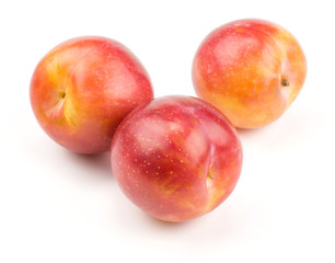 Plums red orange three ripe isolated on white background.