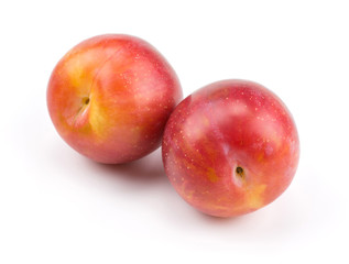 Fototapeta na wymiar Two plums red orange isolated on white background fresh and glossy.