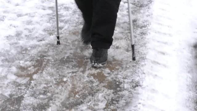 Nordic walking in the snow in winter. Walk with sticks is a kind of physical activity useful for health.