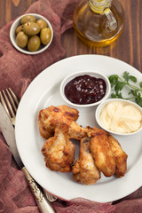 fried chicken with sauces on white plate