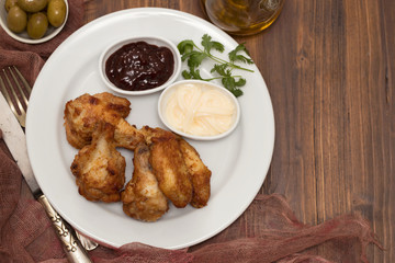 fried chicken with sauces on white plate