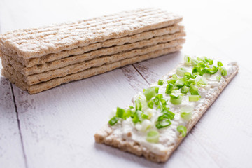 Rye crispbread with soft cheese and fresh herbs. Dietary vegetarian sandwich.Crispy dietary fitness bread.  Food for weight loss space for text