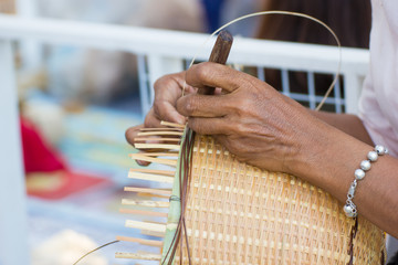 the villagers took bamboo stripes to weave into different forms for daily use utensils of the community’s people in Bangkok Thailand, Thai handmade product.  