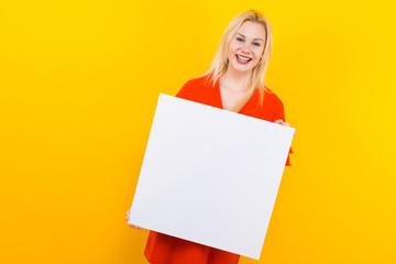 Blonde woman in dress with blank paper