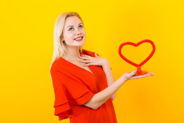 Blonde woman with plastic heart form