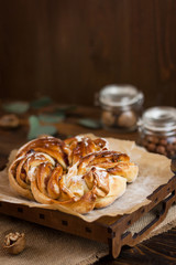 Brioche. Swirl Brioche with sugar powder. Estonian Kringle. Delicious Brioche with sugar and cinnamon/ Wreath. National pastries. Babka.