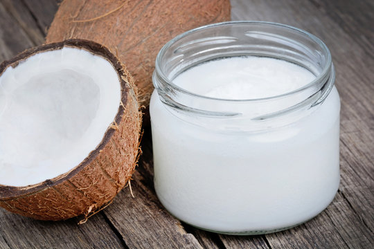 Coconut oil in a jar on wood table