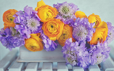Beautiful bouquet of flowers.Yellow ranunculus  and scabious flowers close-up on the table. 