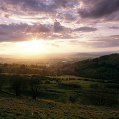 England, Cotswolds, Gloucestershire, sunset view from Birdlip Hill over the Severn Vale and Gloucester