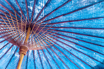 Vintage blue color traditional Japanese or asian paper - cotton parasol umbrella background.