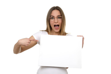 Naklejka premium Hübsche blonde Frau mit Brille erstaunt zeigt auf eine leere Tafel in ihren Händen