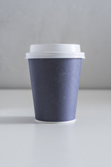Disposable coffee cup on a neutral background