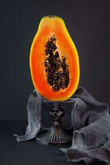 fresh ripe papaya on a napkin and slate plate kitchen table can be used as background